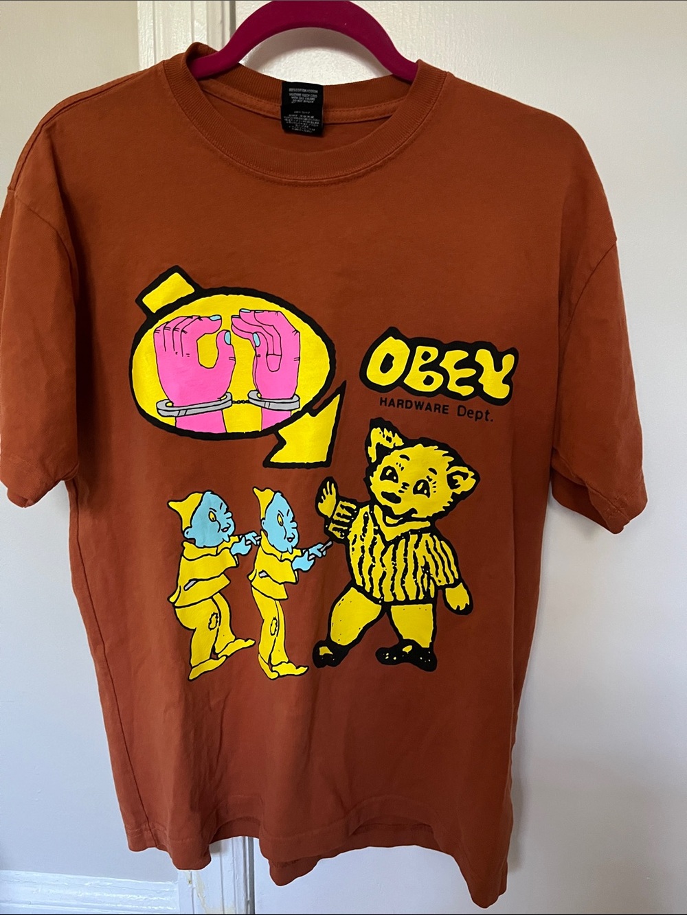 Obey Men's Rust Brown Graphic Tee with Yellow & Pink Print